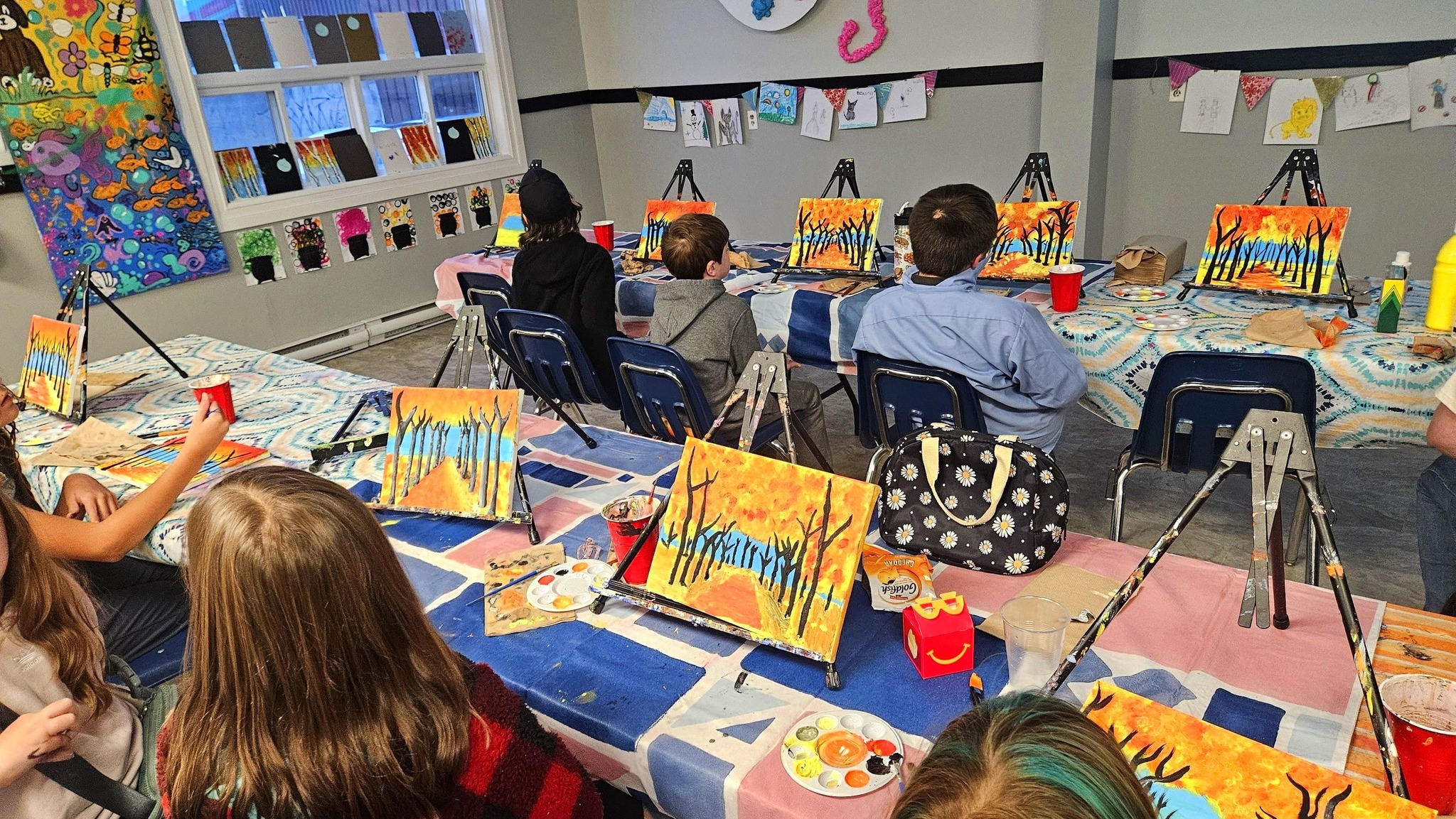 Young artists painting in class at Morgan Art Academy